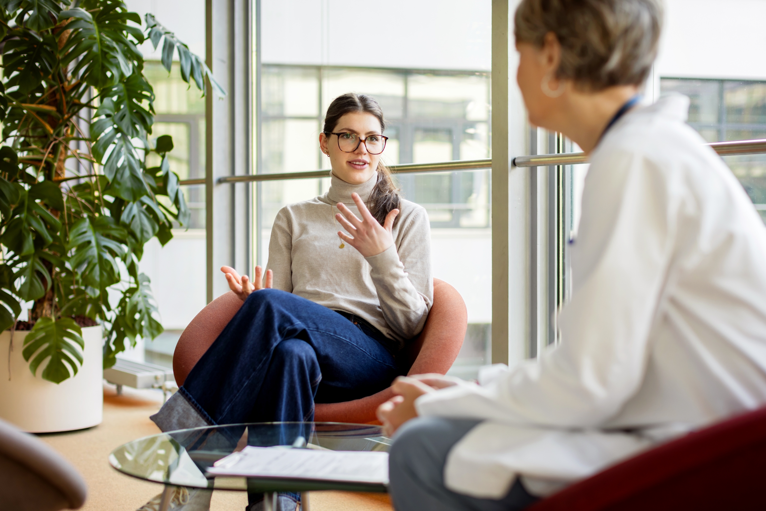 Woman talking with her doctor in a bright, comfortable office